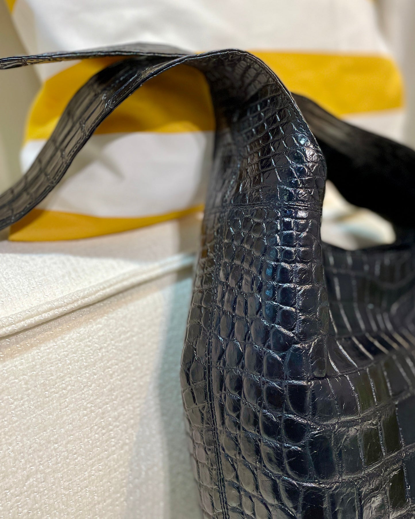 Close-up of a black textured handbag with a blurred background