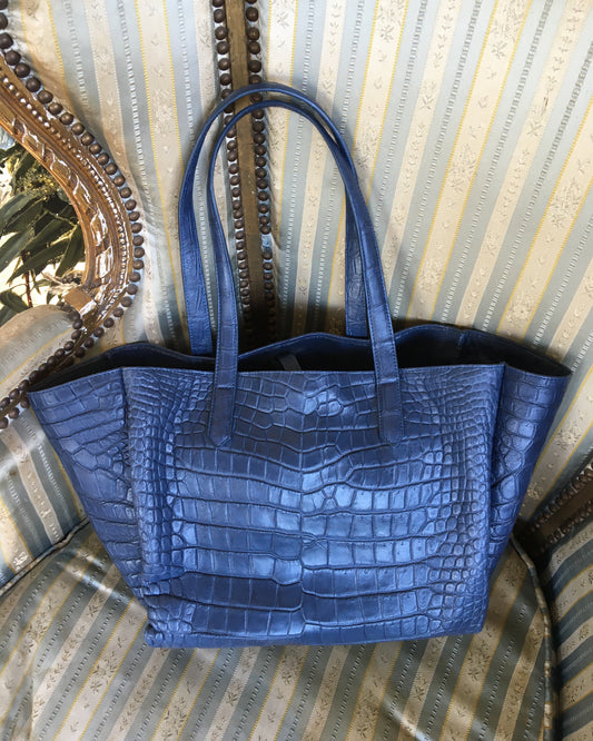 Blue textured handbag on a textured surface
