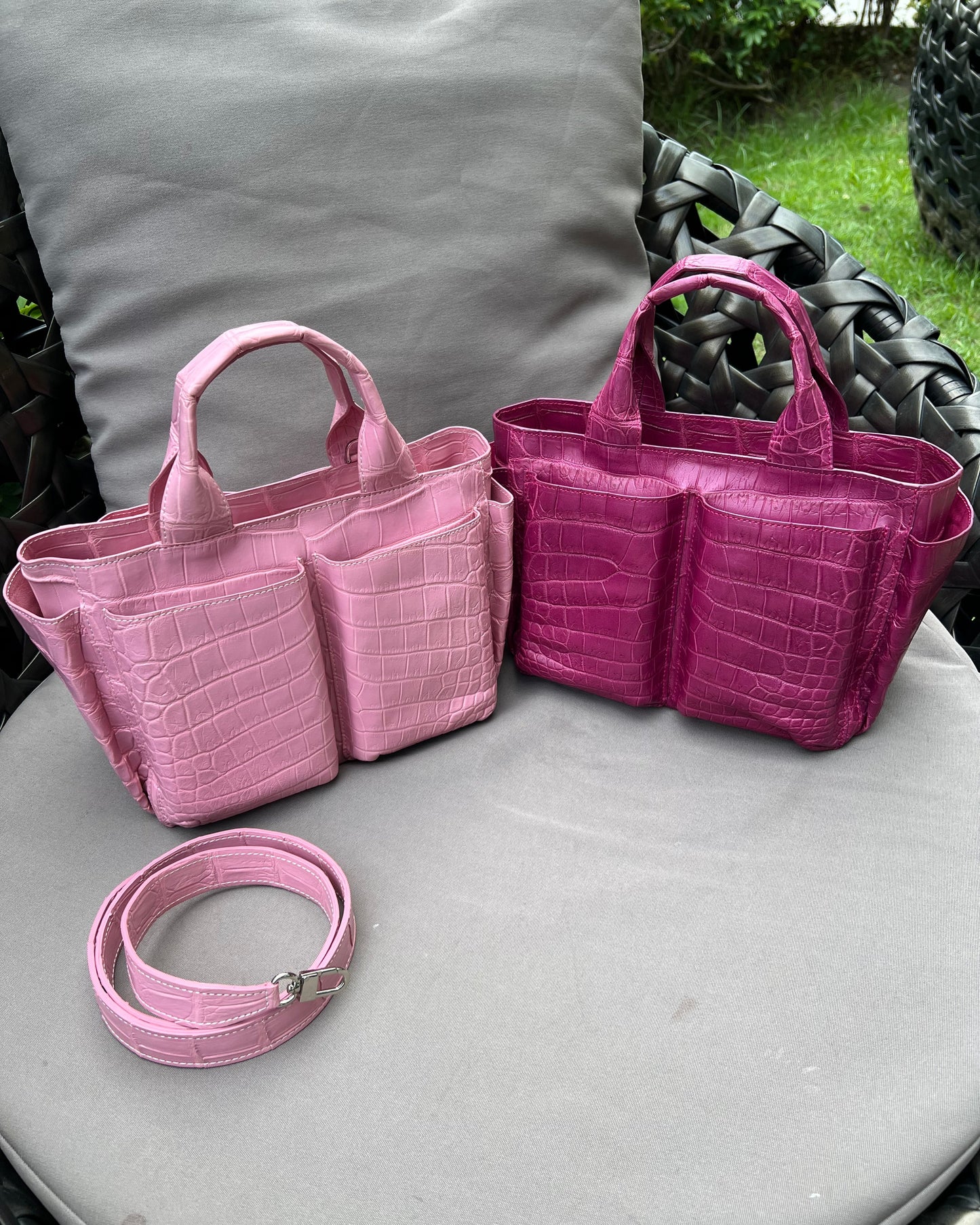 Pink and lilac bag on a gray garden chair in the background.